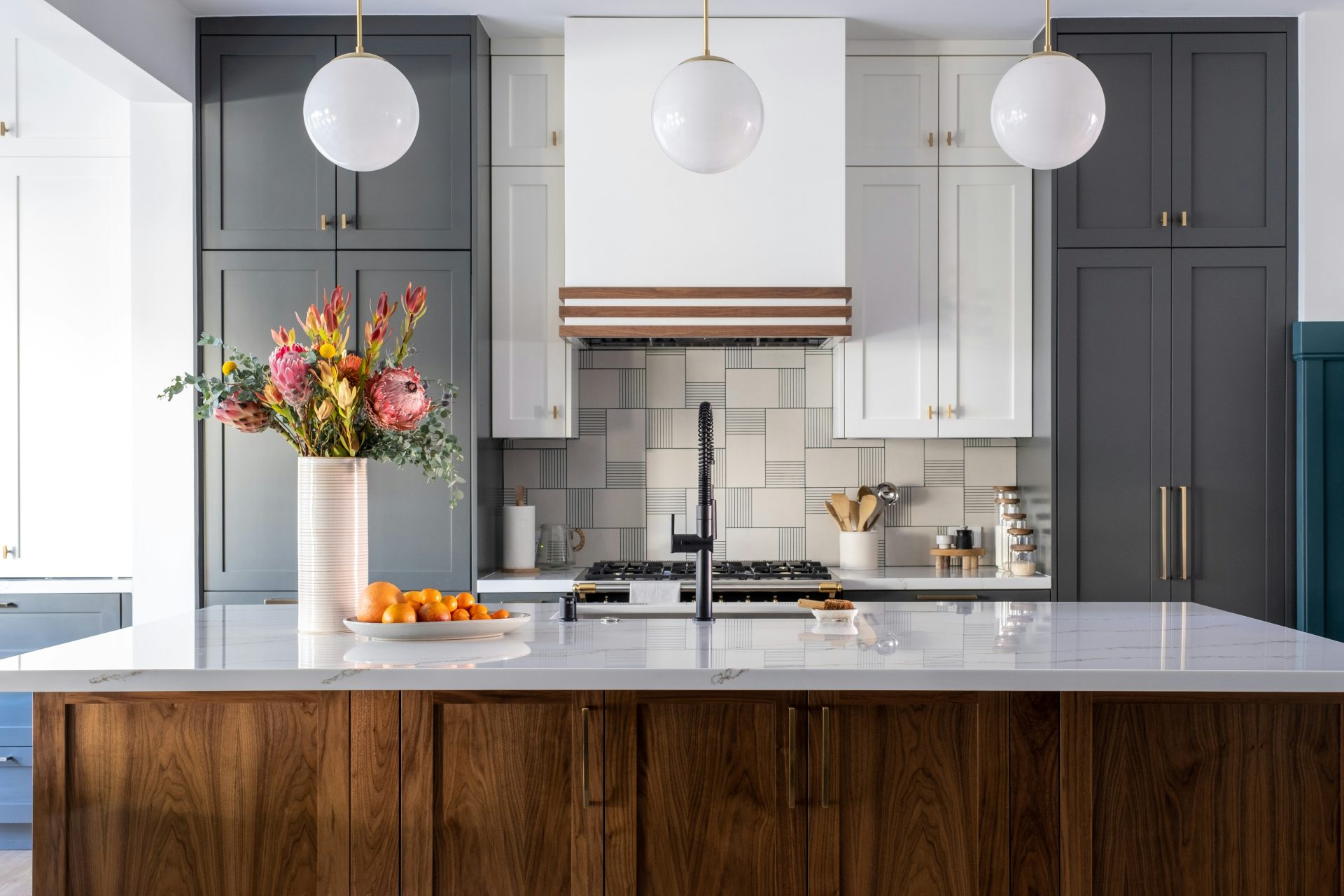 a kitchen with a marble counter top and wooden cabinets