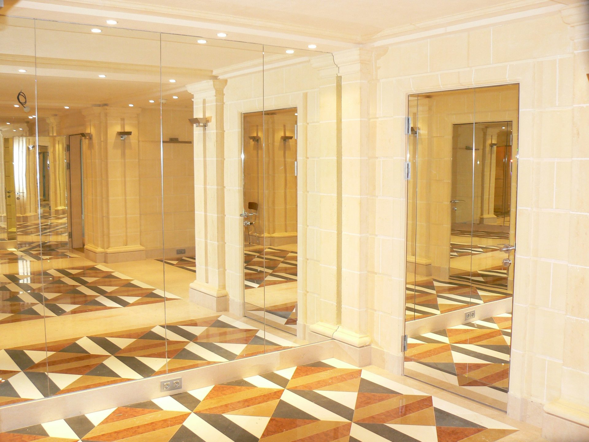 A large room with a checkered floor and mirrors